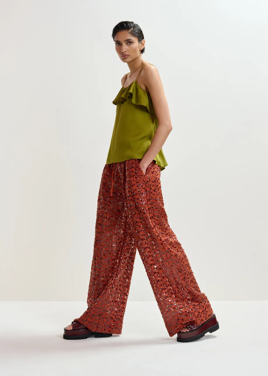 Groen topje met volant en lint op de rug