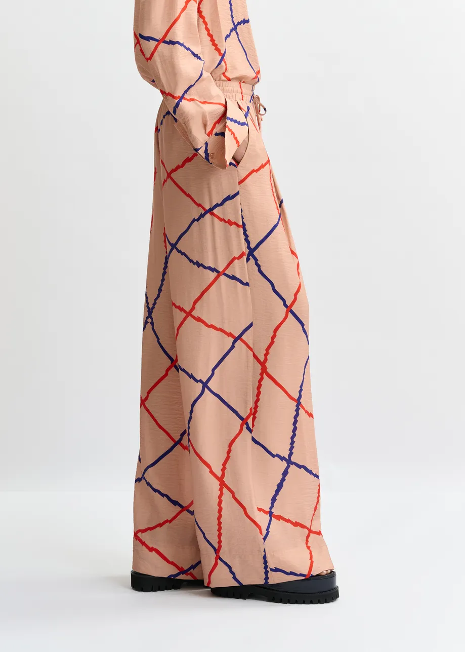 Lichtroze, rood en blauw geruite broek met brede pijp