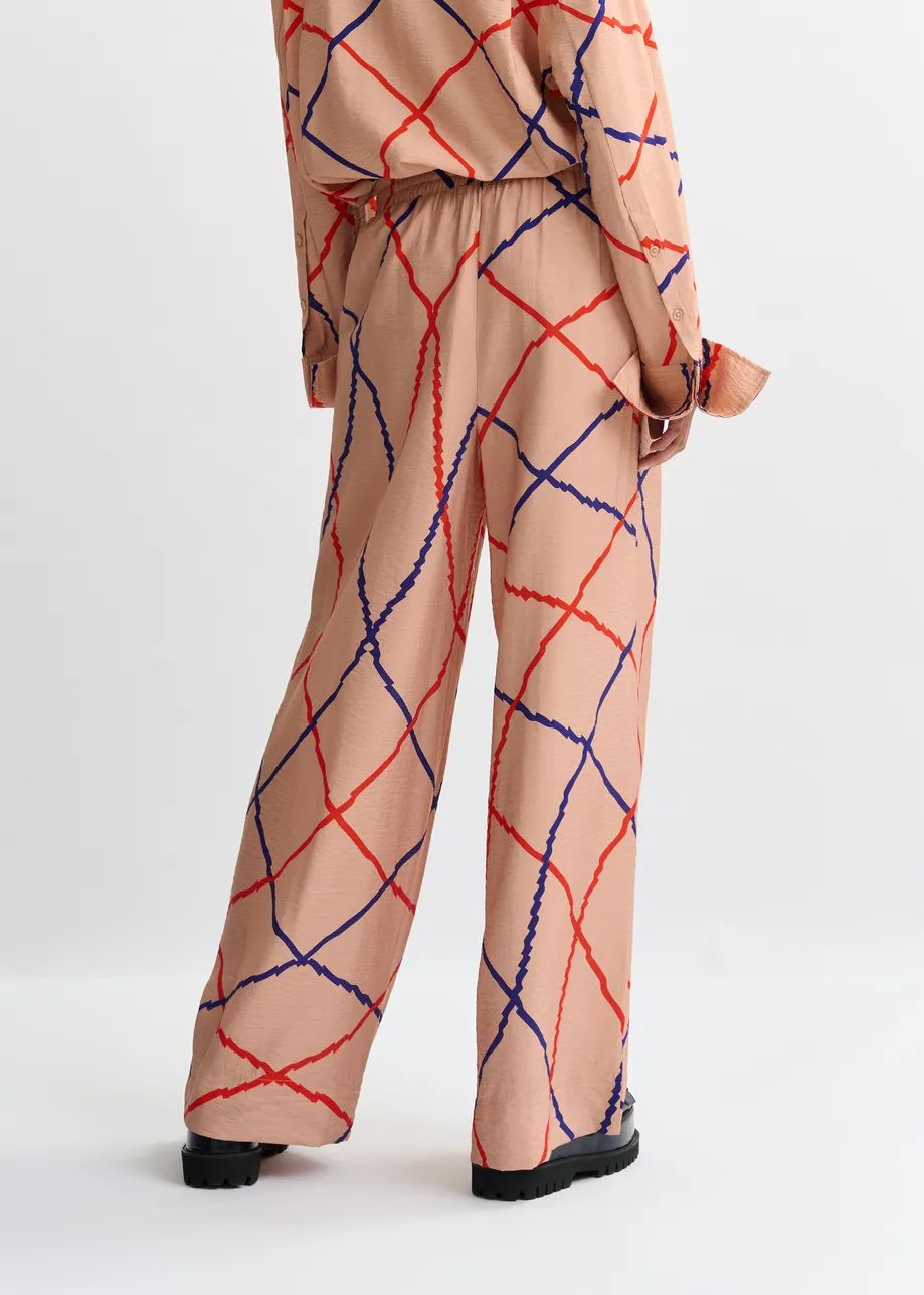 Lichtroze, rood en blauw geruite broek met brede pijp