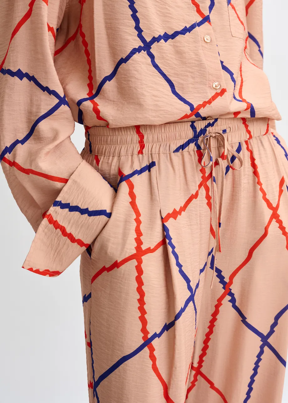 Lichtroze, rood en blauw geruite broek met brede pijp