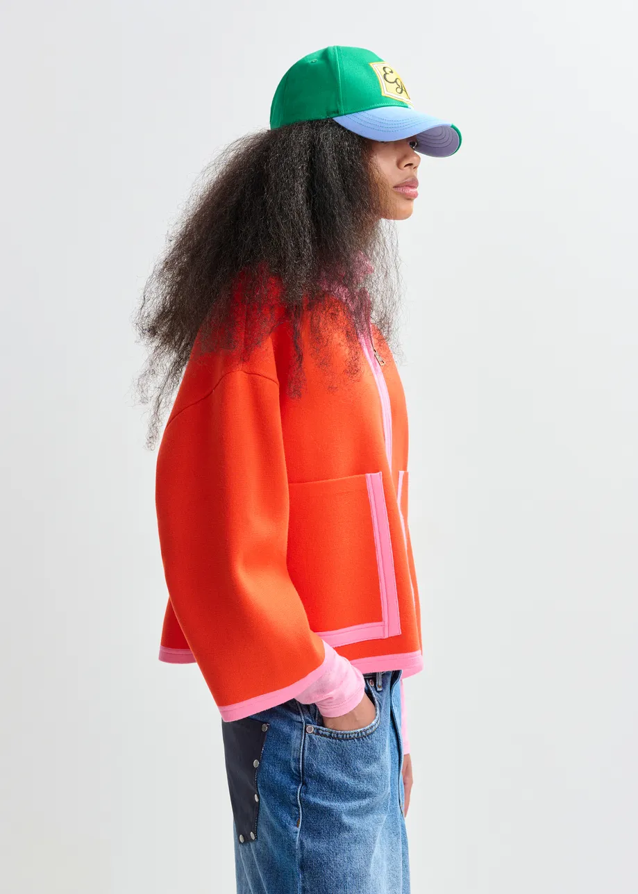 Bright orange and pink cardigan with contrasting trims and zip fastening