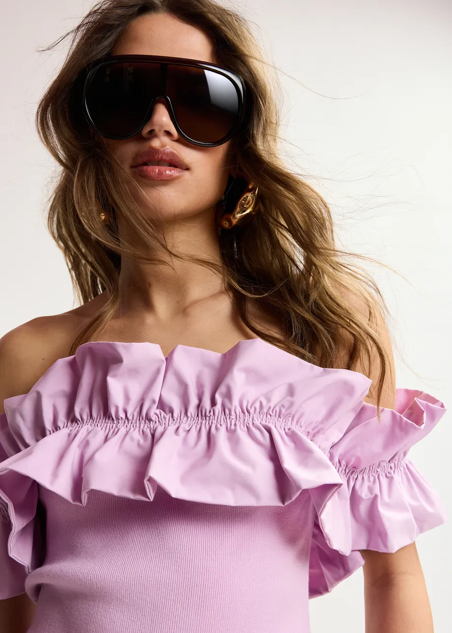 Light pink off-shoulder knit top with ruffle trim