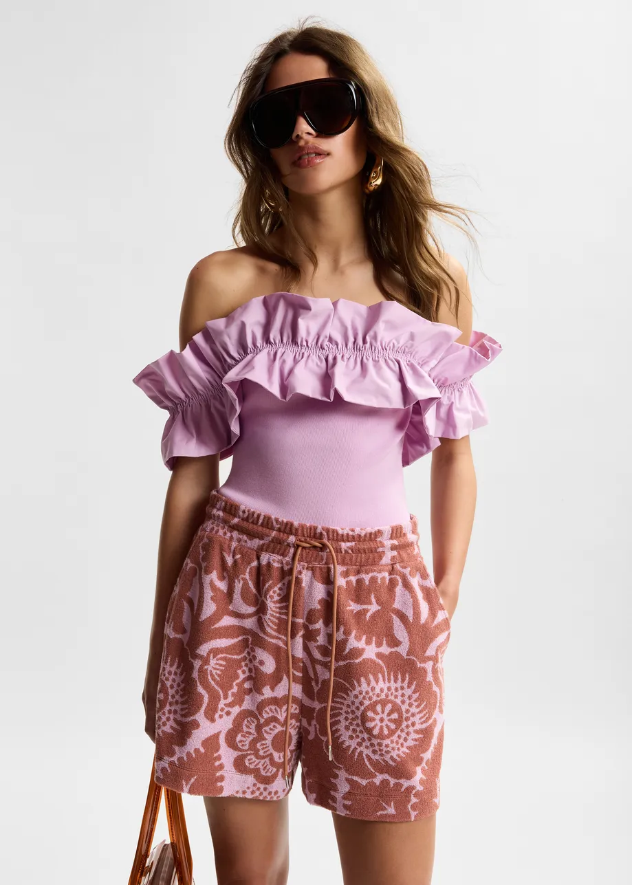 Light pink off-shoulder knit top with ruffle trim