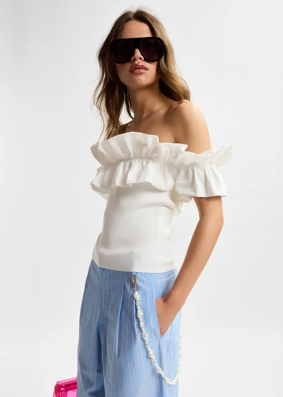 White off-shoulder knit top with ruffle trim