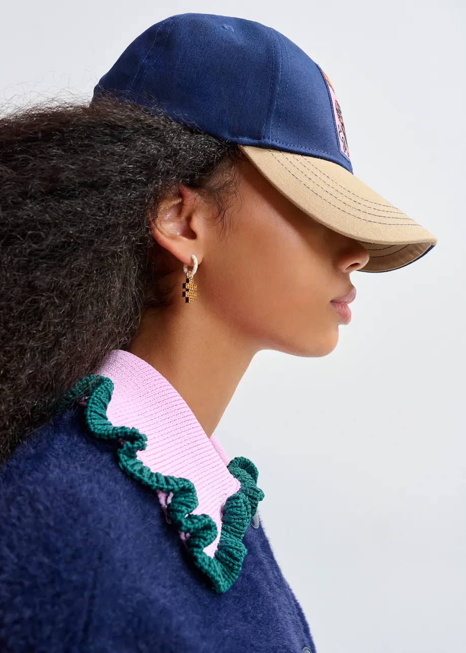 Navy cardigan with contrasting purple and dark green ruffle collar