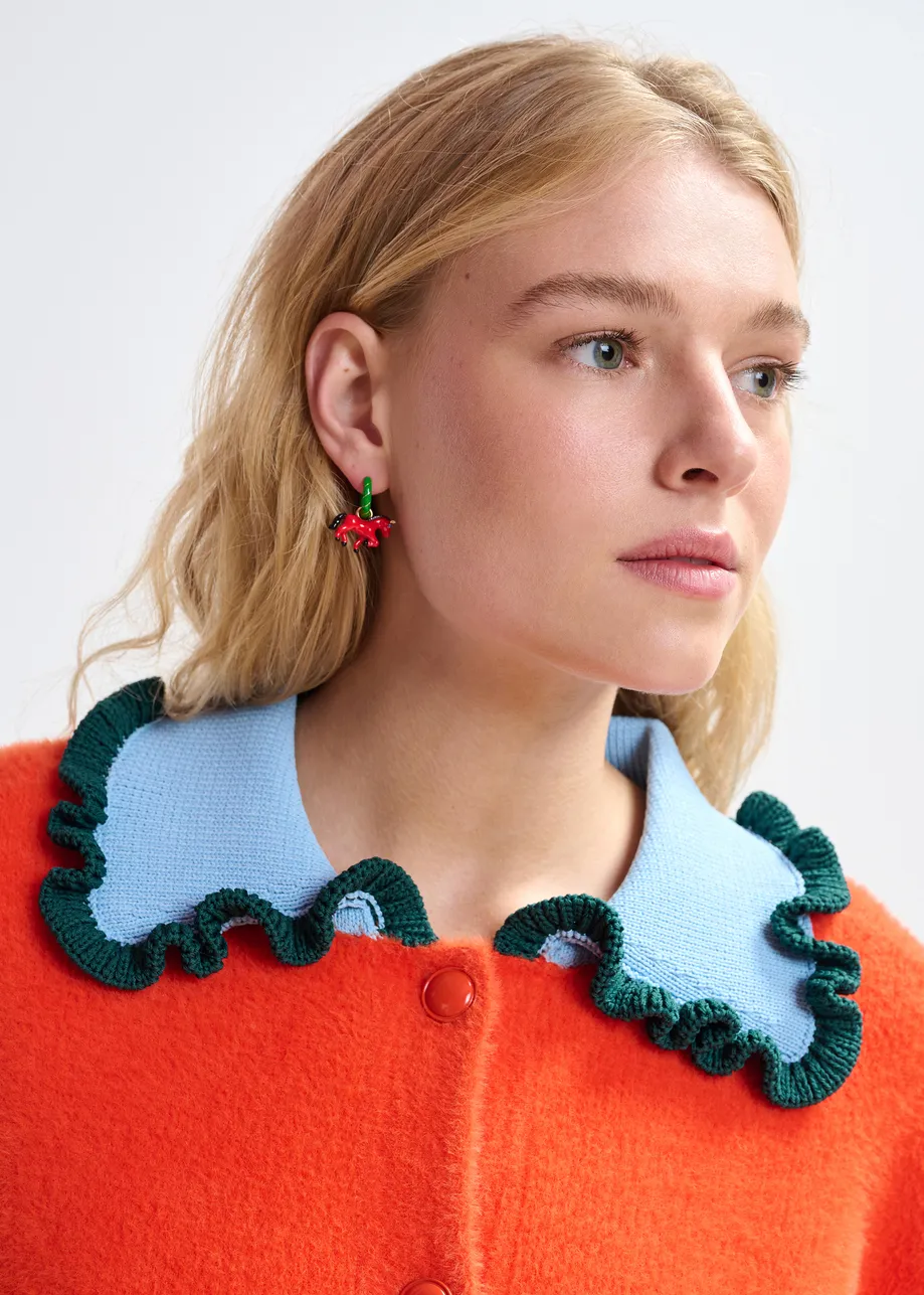 Orange cardigan with contrasting light blue and dark green ruffle collar