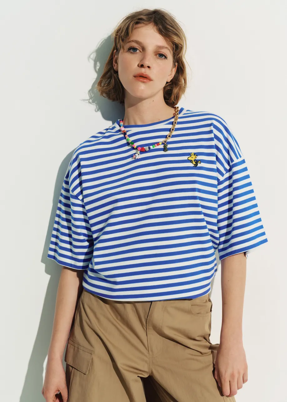 Blue and off-white striped T-shirt with yellow Peanuts™ Woodstock detail