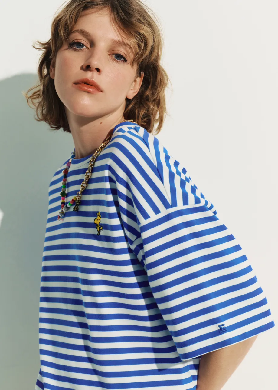 Blue and off-white striped T-shirt with yellow Peanuts™ Woodstock detail