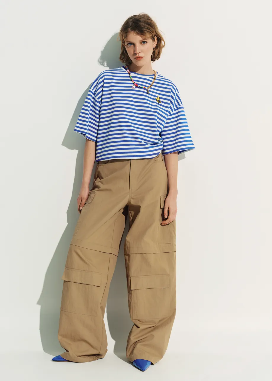 Blue and off-white striped T-shirt with yellow Peanuts™ Woodstock detail