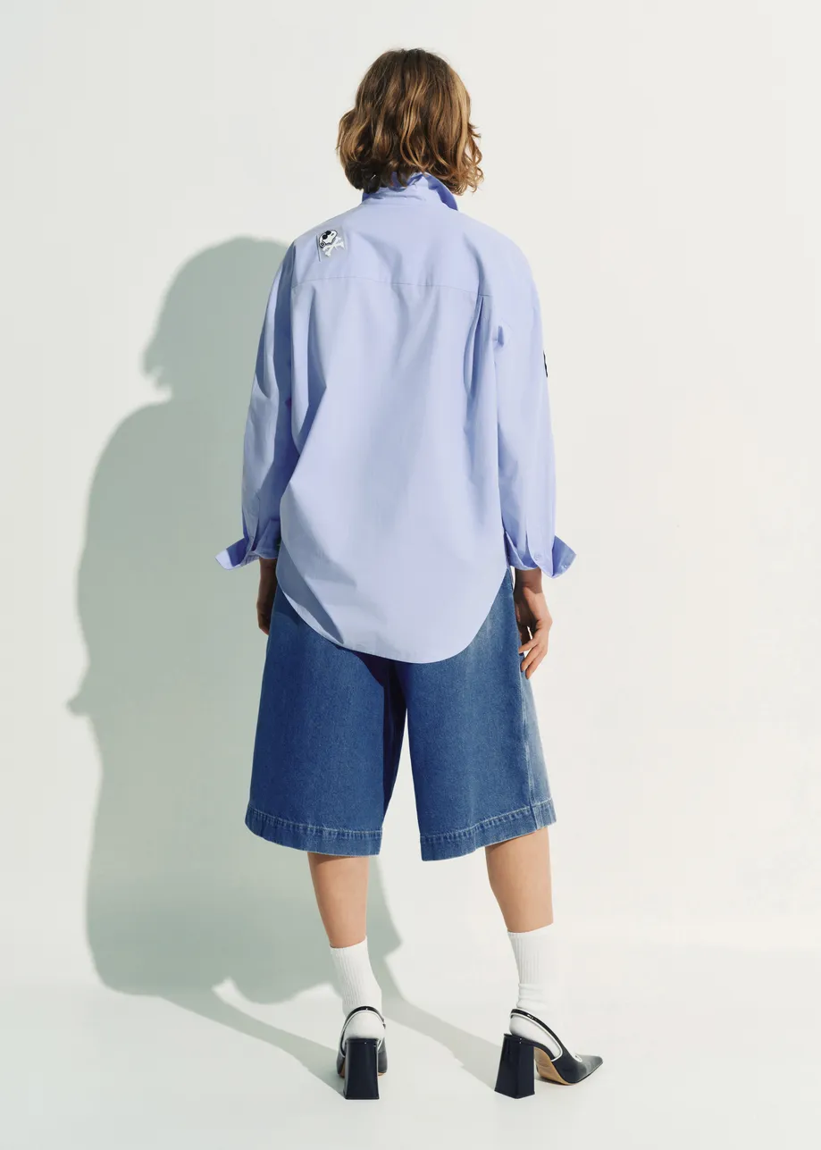 Light blue cotton shirt with multicolored Peanuts™ Snoopy patches