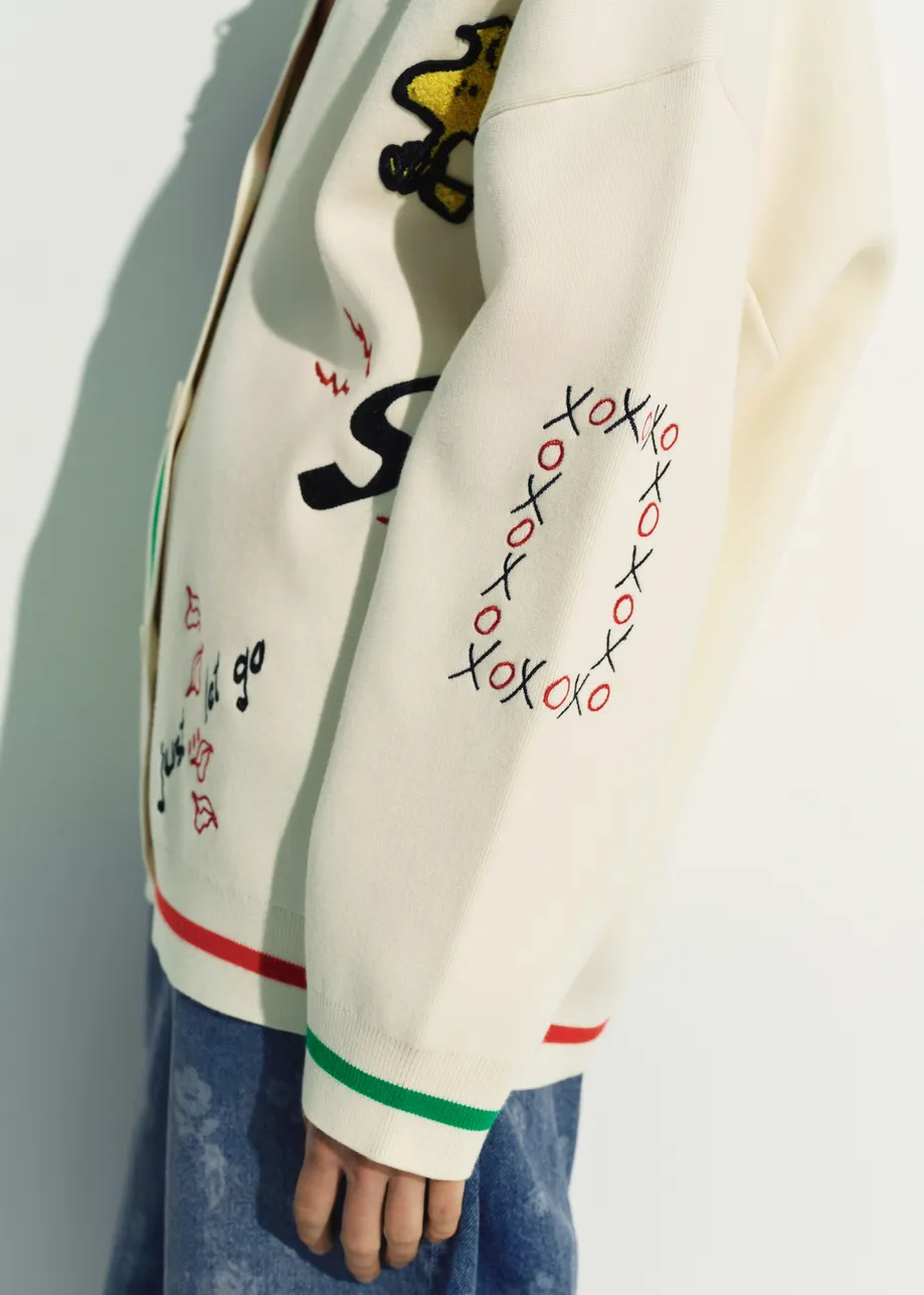Off-white knit cardigan with multicolored Peanuts™ Snoopy and Woodstock patches