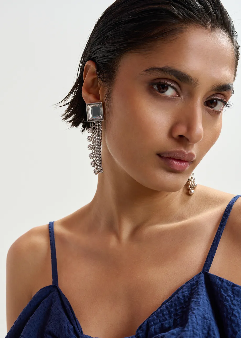 Silver stud earrings with rhinestone and bead-embellished chain strands