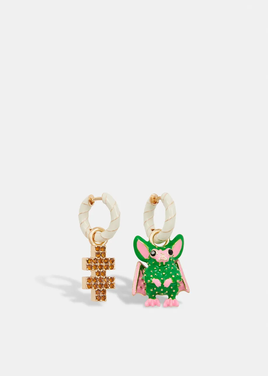 Off-white and gold hoop earrings with bat and puzzle pendants