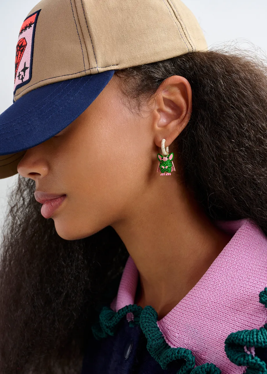 Off-white and gold hoop earrings with bat and puzzle pendants