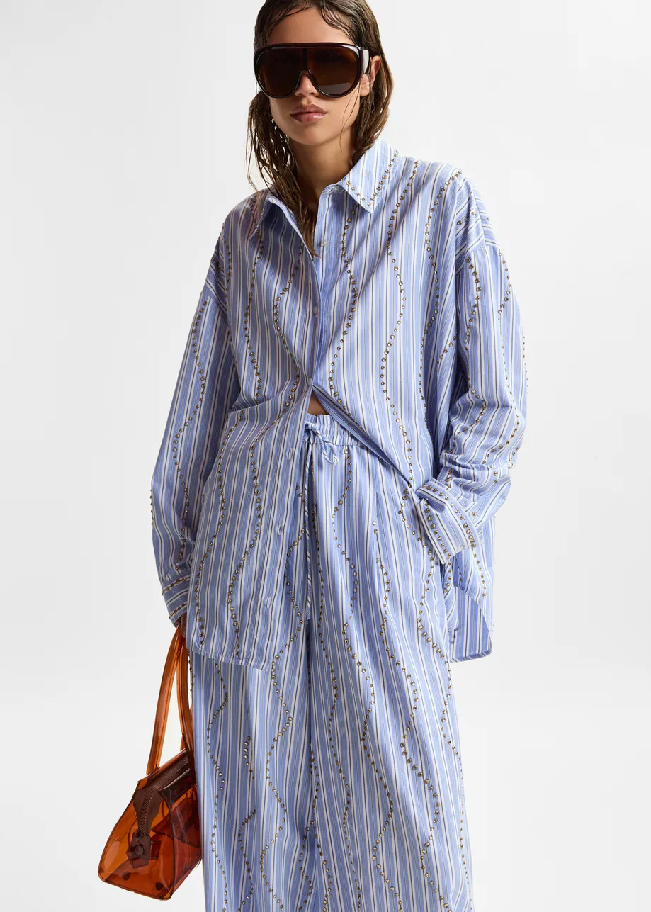 Light blue and white striped oversized shirt with stud embellishments