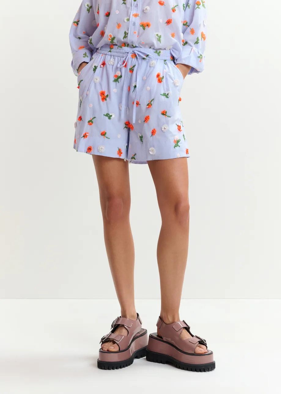 Light blue shorts with orange and green sequin, rhinestone and bead flower embellishments
