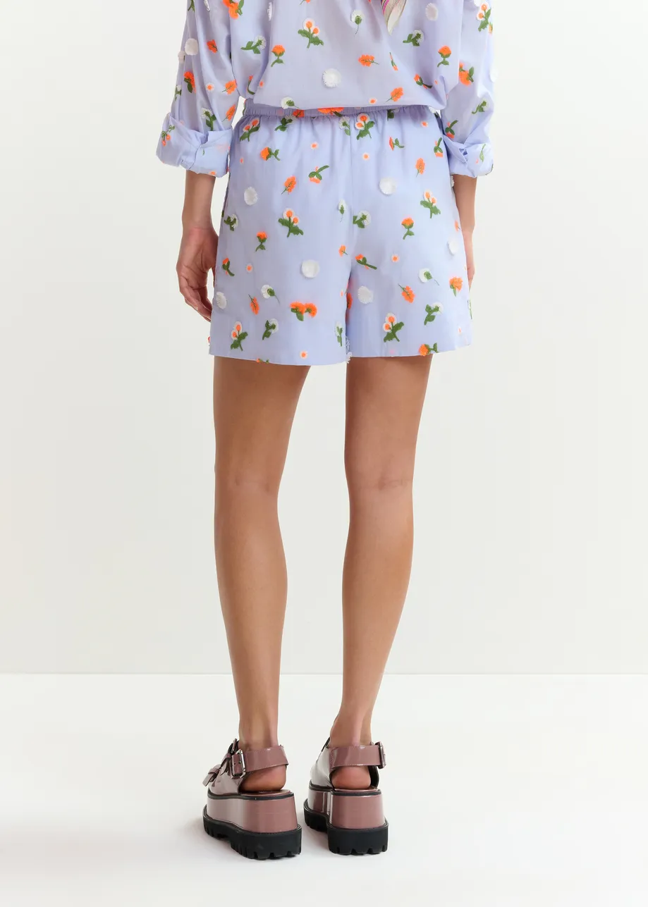 Light blue shorts with orange and green sequin, rhinestone and bead flower embellishments