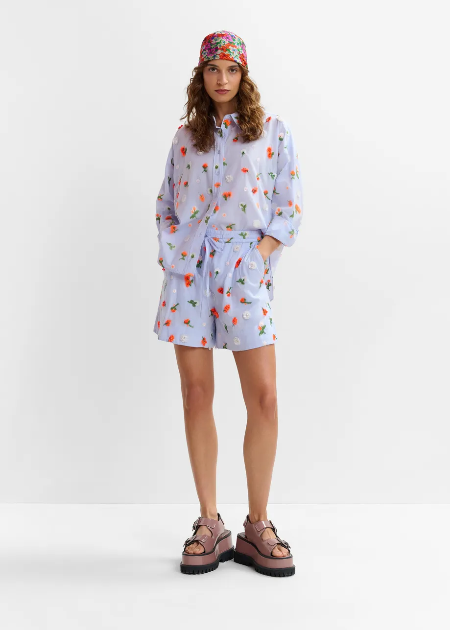 Light blue shorts with orange and green sequin, rhinestone and bead flower embellishments