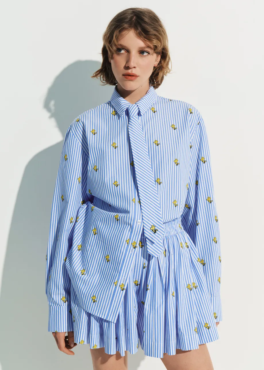 Light blue and white striped oversized cotton shirt with yellow Peanuts™ print