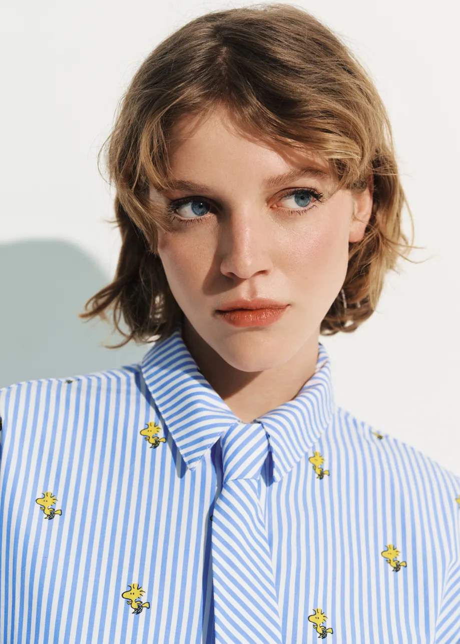 Light blue and white striped oversized cotton shirt with yellow Peanuts™ print