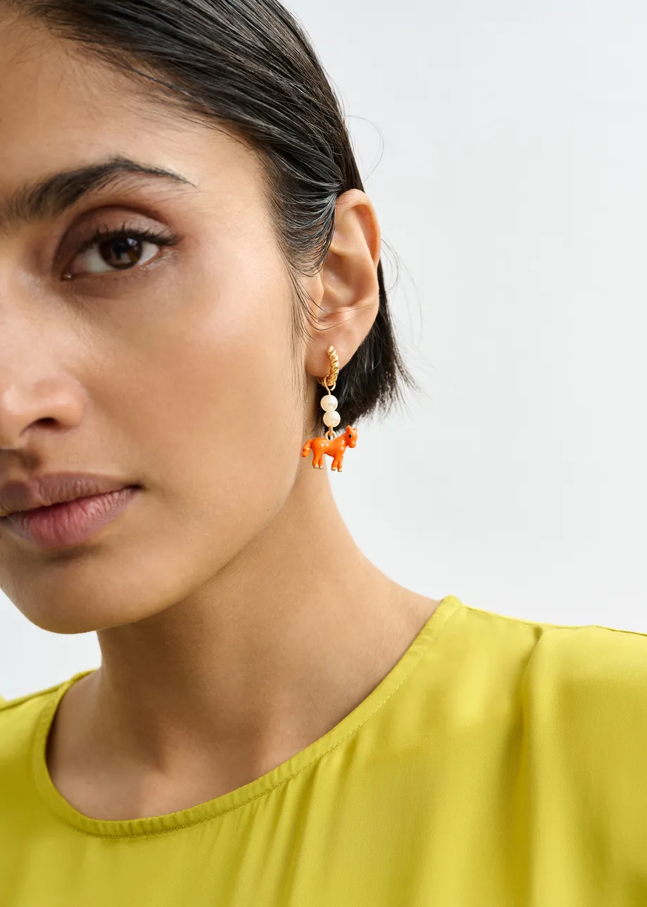 Gold hoop earrings with orange horse and pink and navy boy on a chair pendant