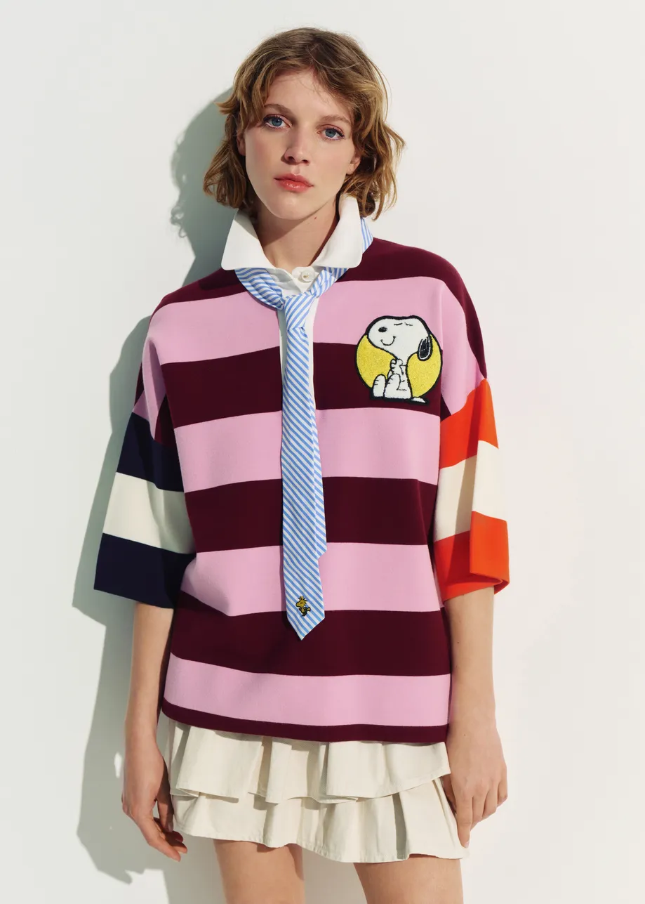 Pink and burgundy striped polo sweater with Peanuts™ patch and text