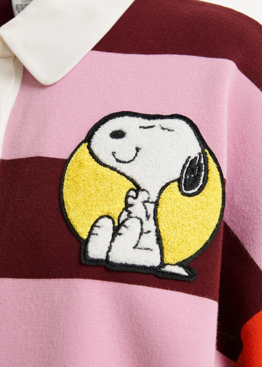 Pink and burgundy striped polo sweater with Peanuts™ patch and text