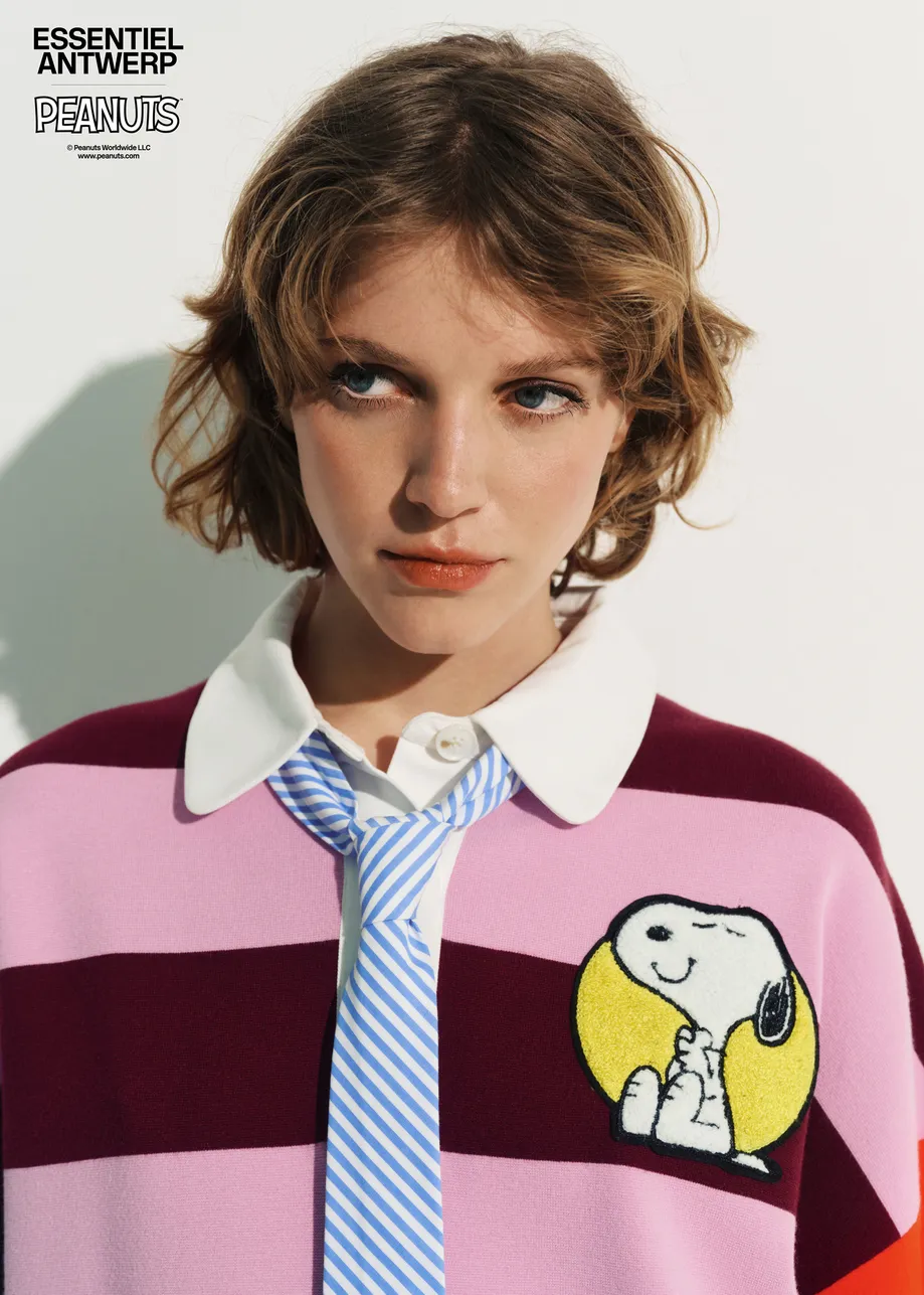 Pink and burgundy striped polo sweater with Peanuts™ patch and text
