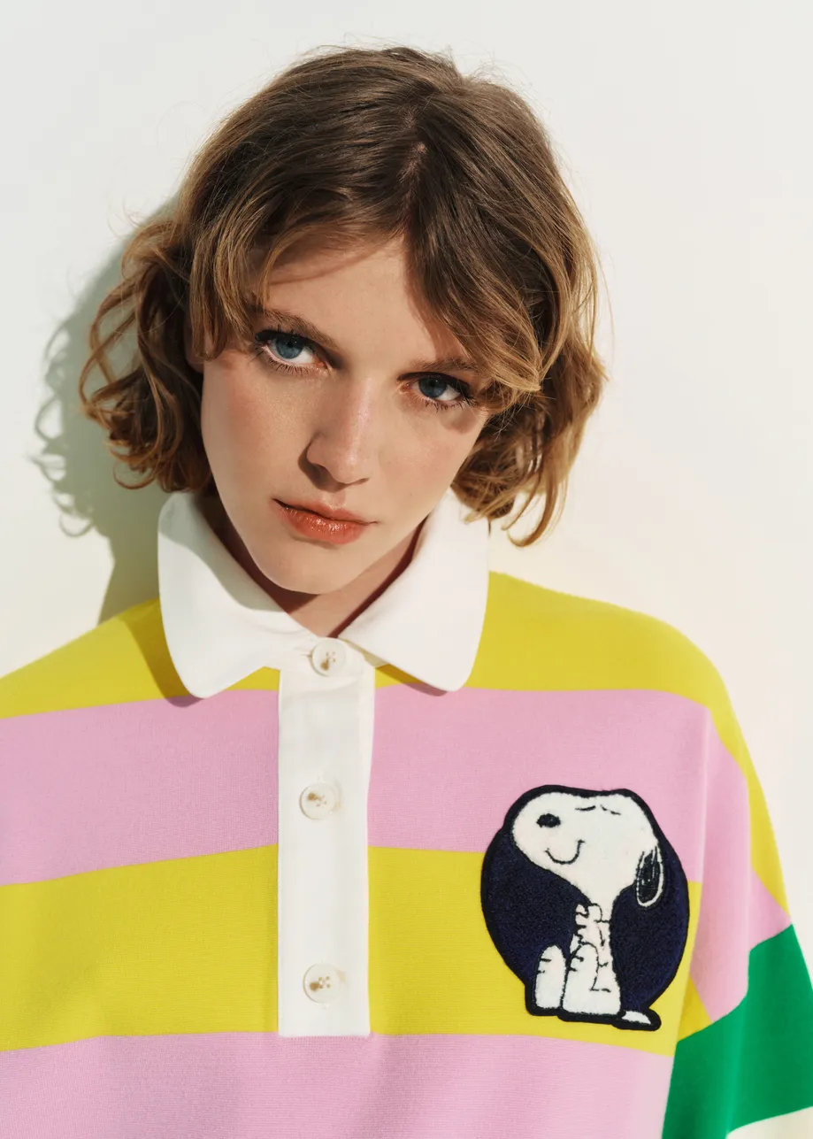 Lilac and yellow striped polo sweater with Peanuts™ patch and text