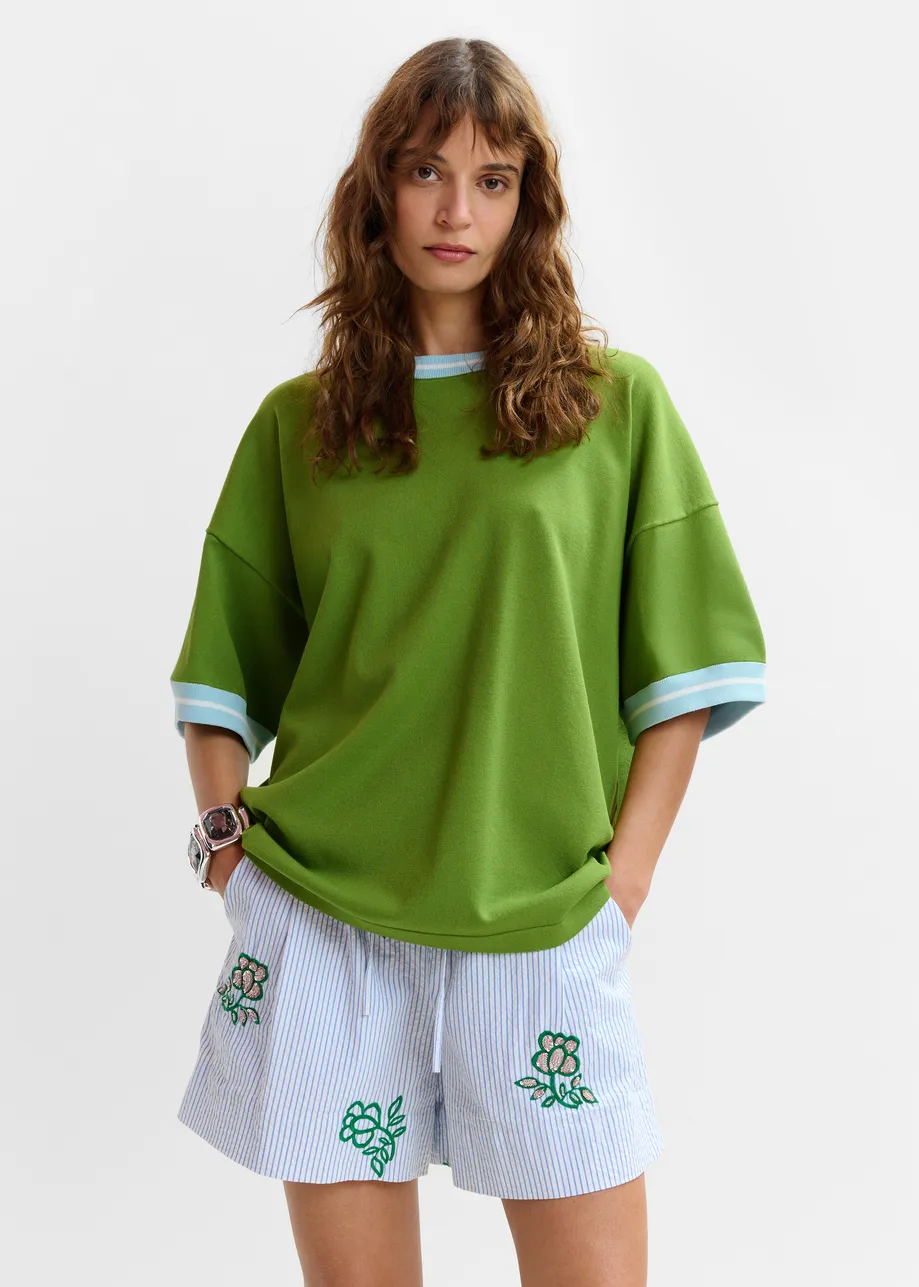 Green knit T-shirt with light blue contrasting trim