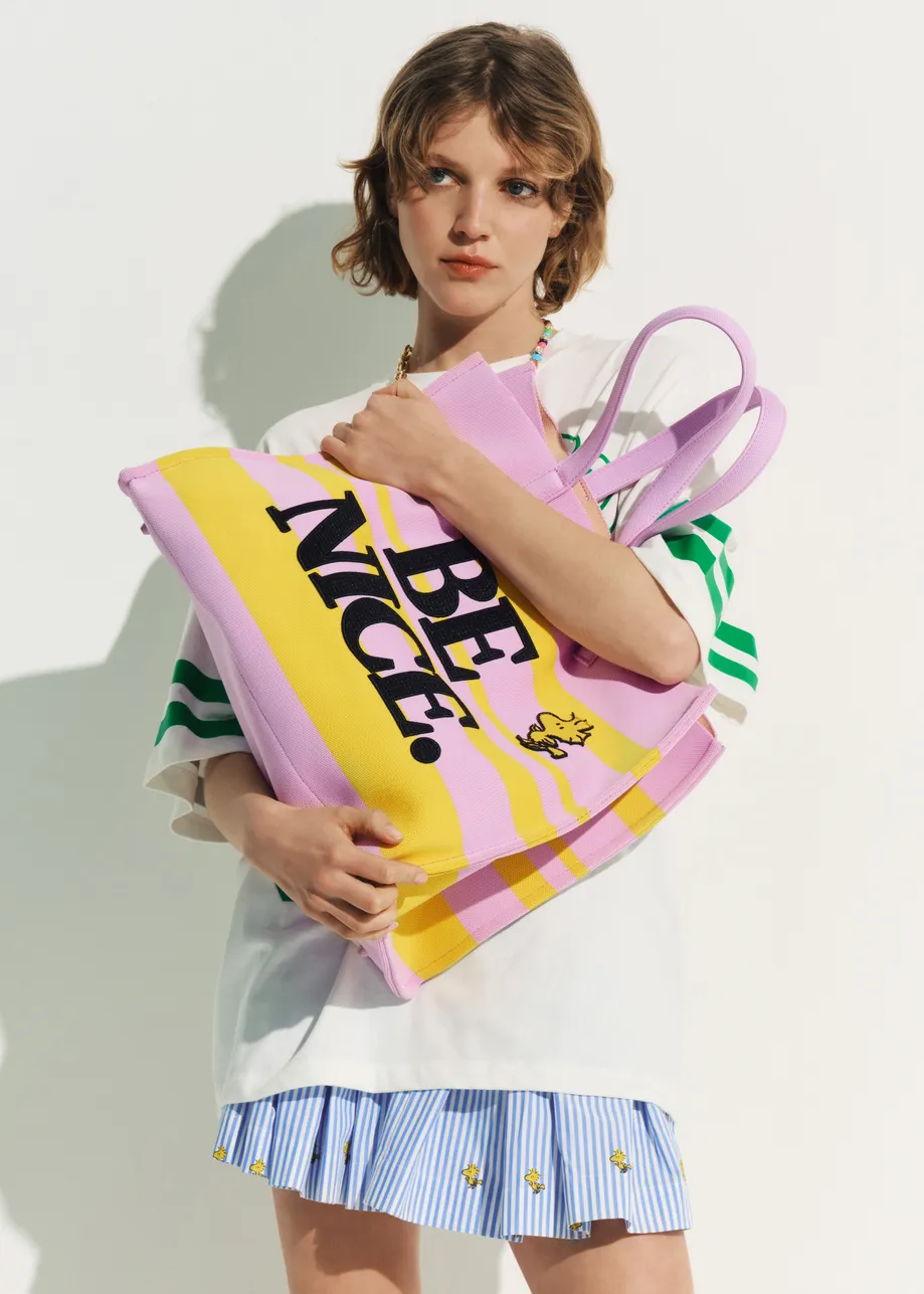 Lilac and yellow striped shopper bag with Peanuts™ Snoopy graphics and black text print