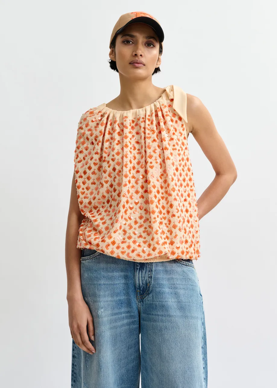 Oranje asymmetrische top met pailletten en strik