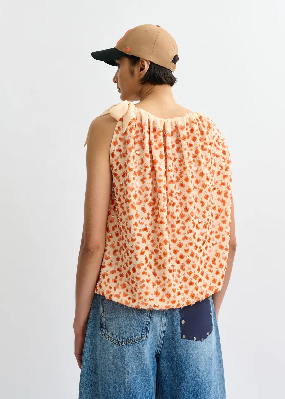 Oranje asymmetrische top met pailletten en strik
