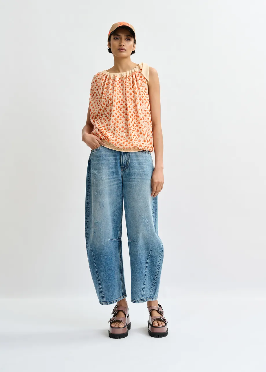Oranje asymmetrische top met pailletten en strik