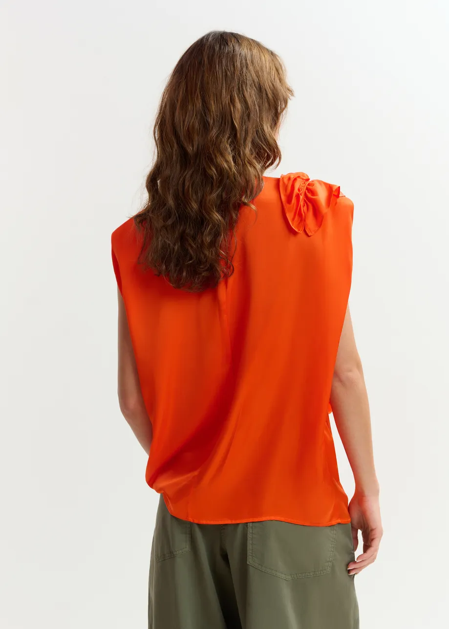 Orange sleeveless top with ruffle detail 