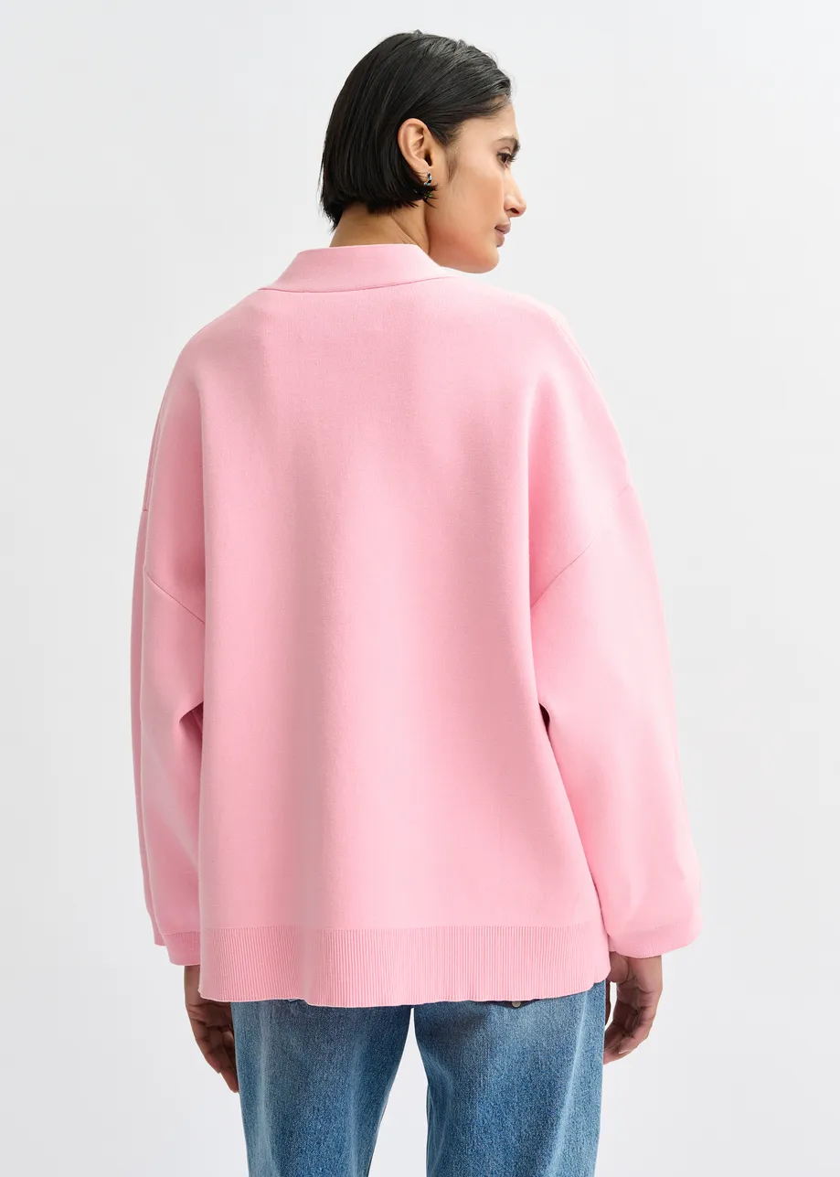Roze cardigan met bloemknopen