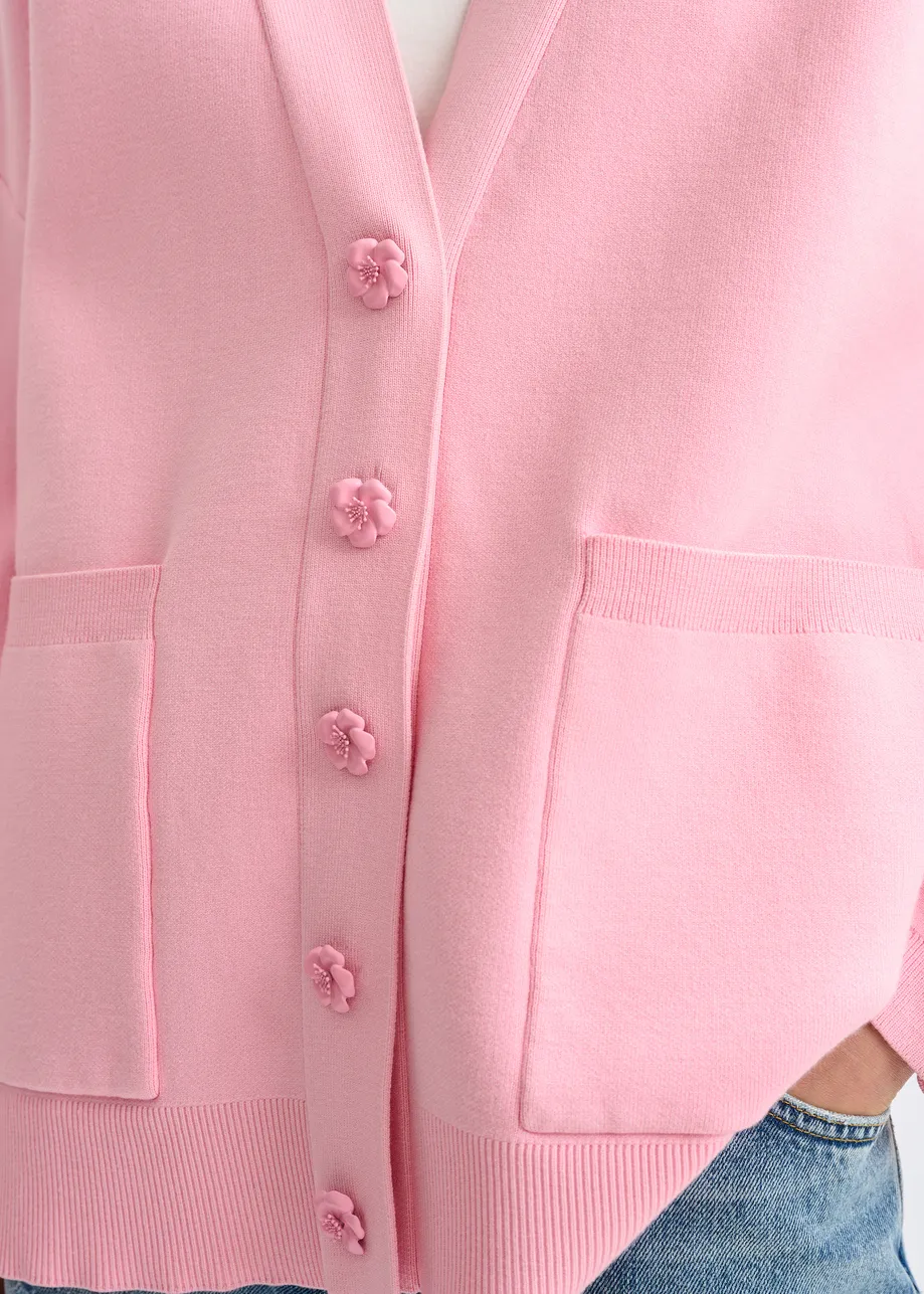 Roze cardigan met bloemknopen