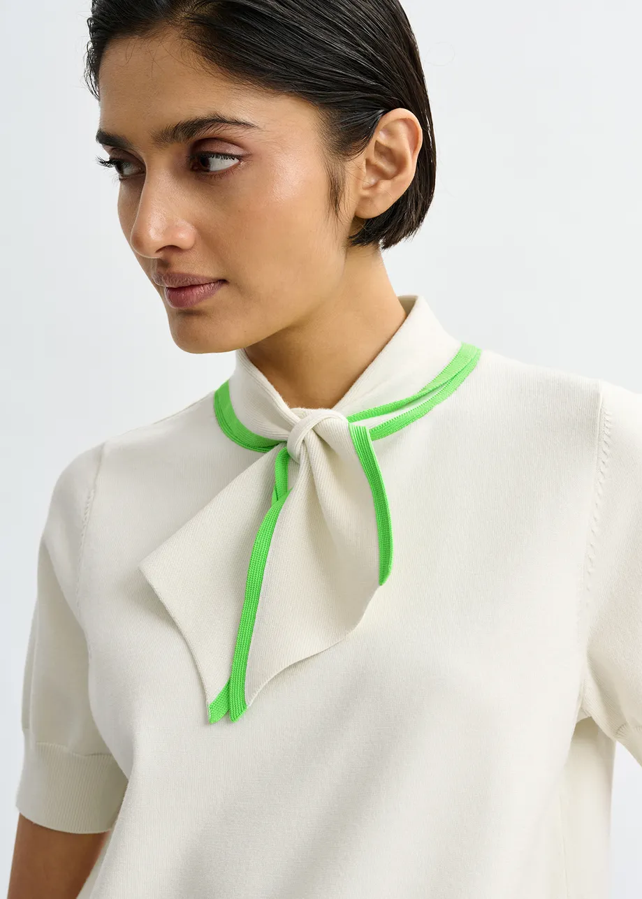 Off-white fine-knit polo with light green scarf-like contrast collar