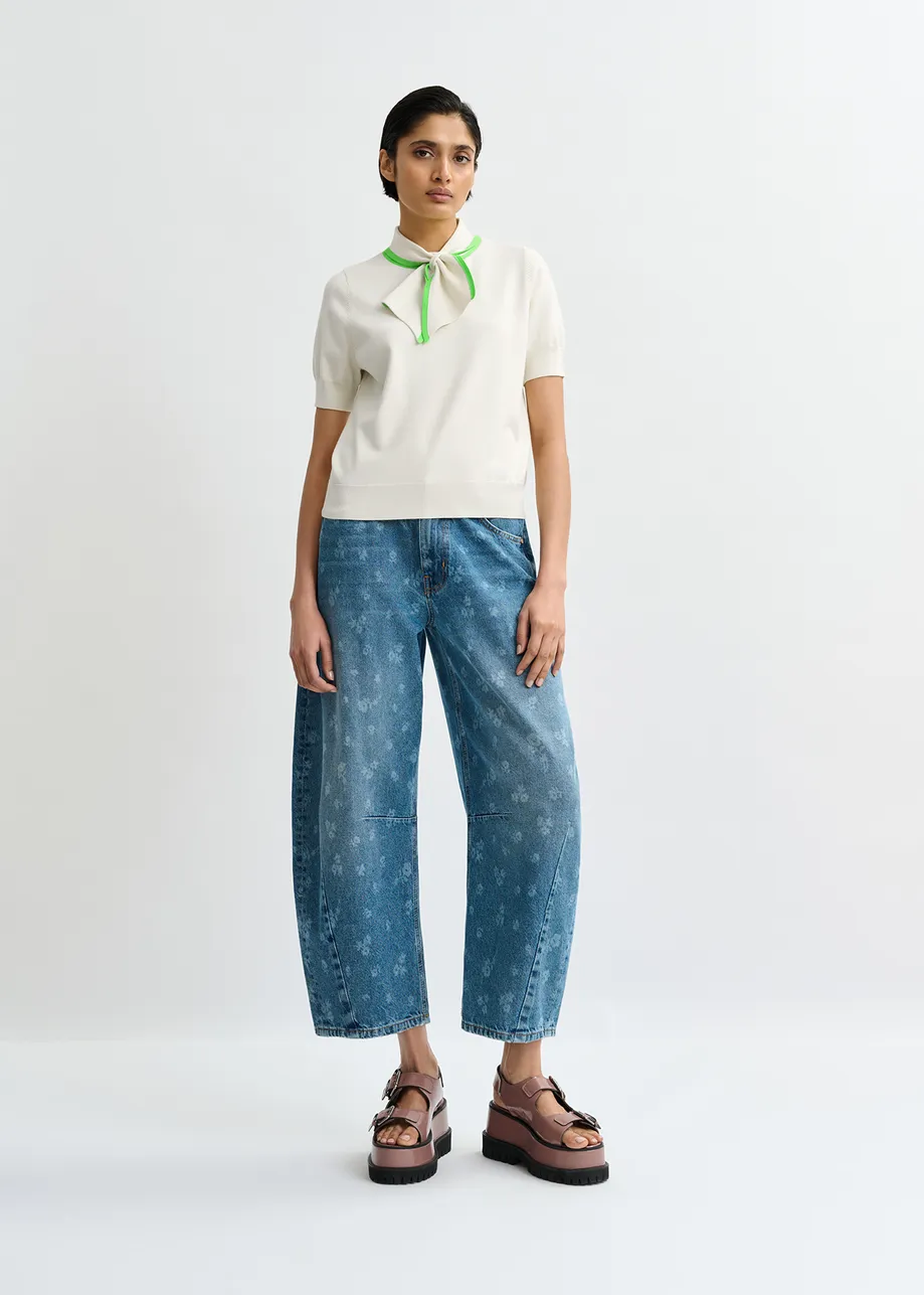 Off-white fine-knit polo with light green scarf-like contrast collar