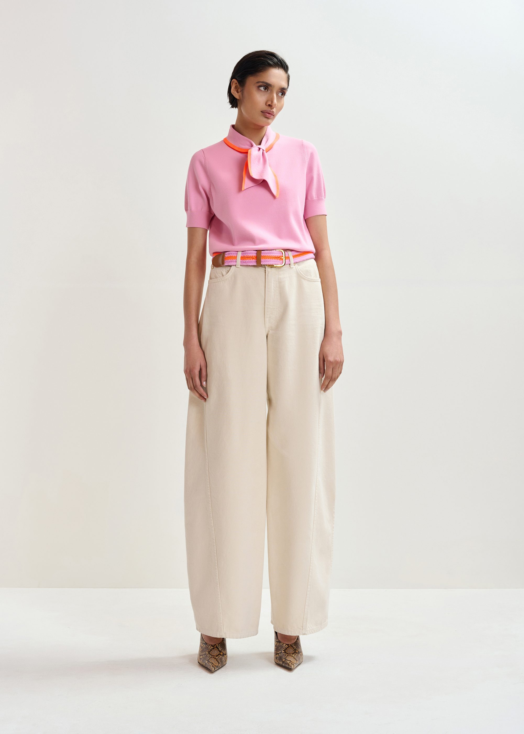 Pink fine-knit polo with orange scarf-like contrast collar