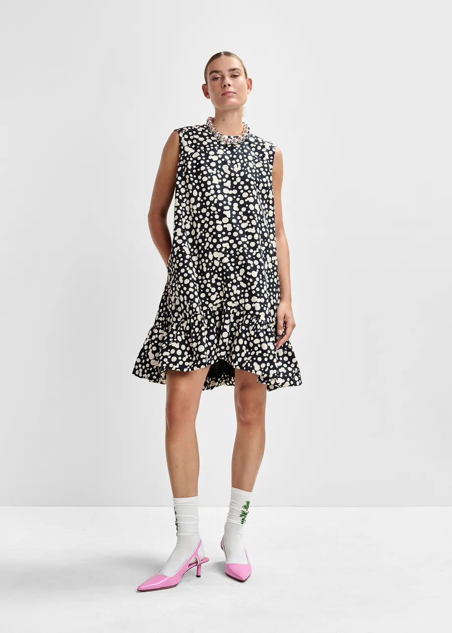 Zwart-witte mini-jurk met open rug en strik