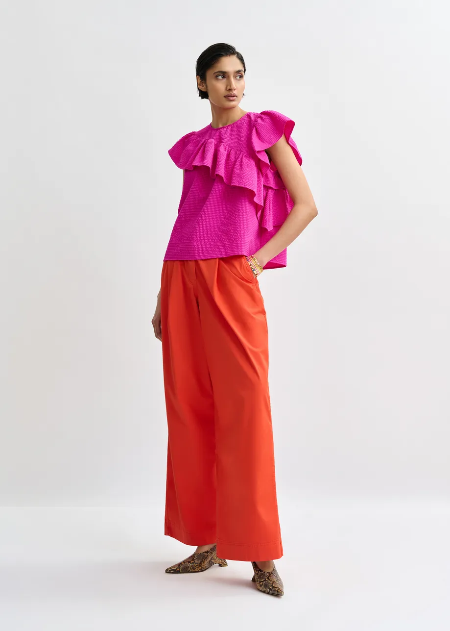 Pink asymmetrical top with ruffle details