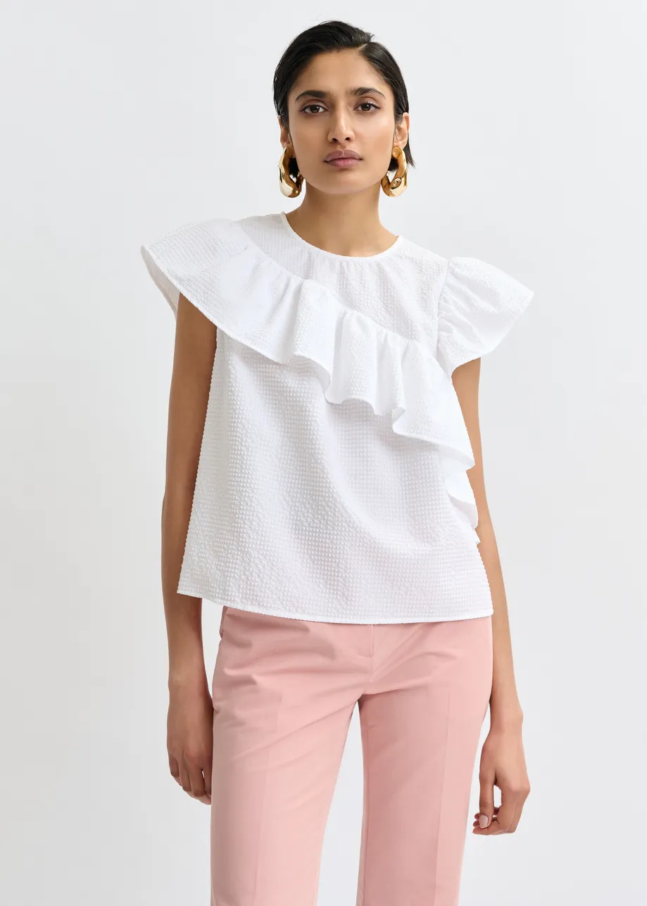 White asymmetrical top with ruffle details