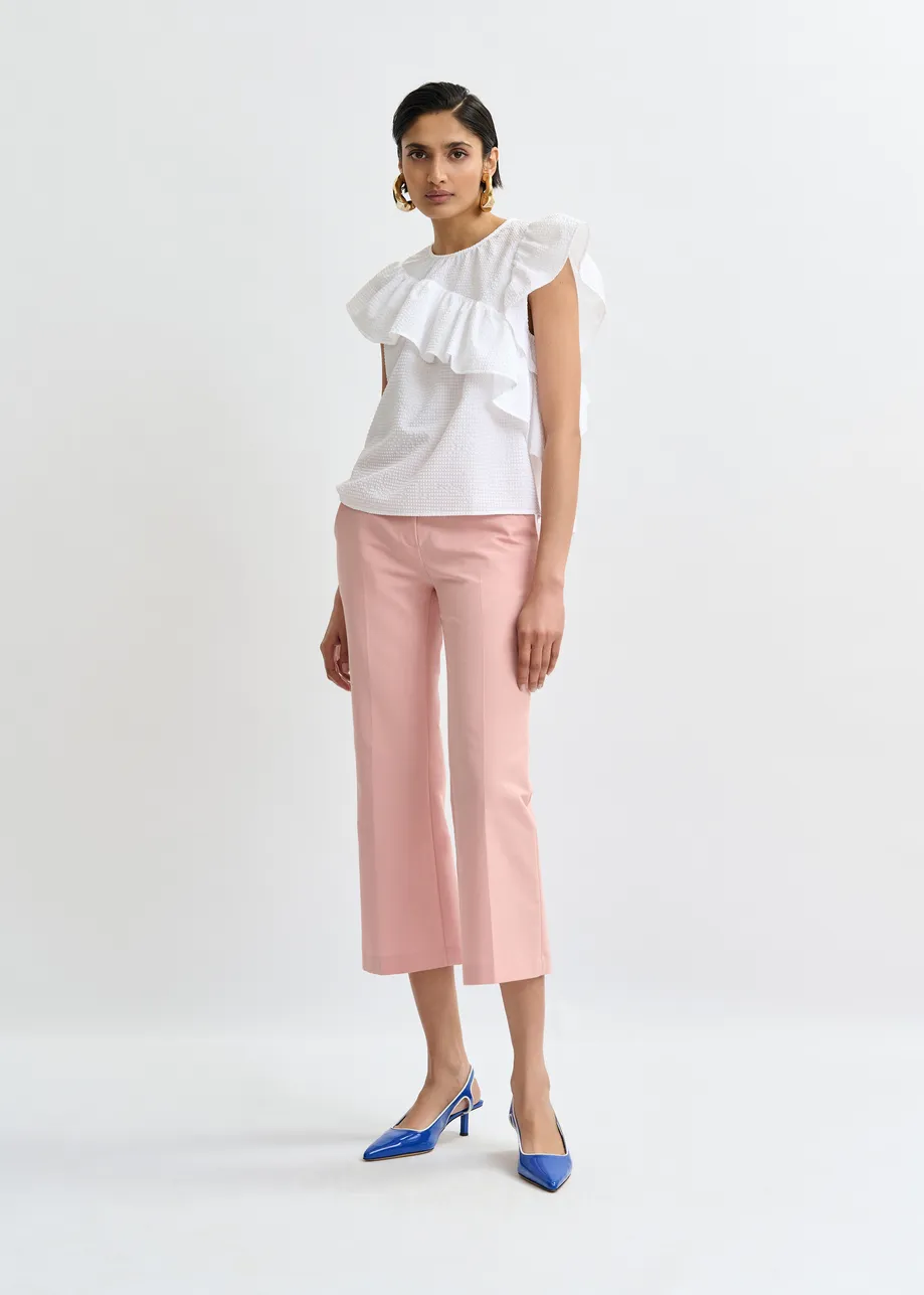 White asymmetrical top with ruffle details