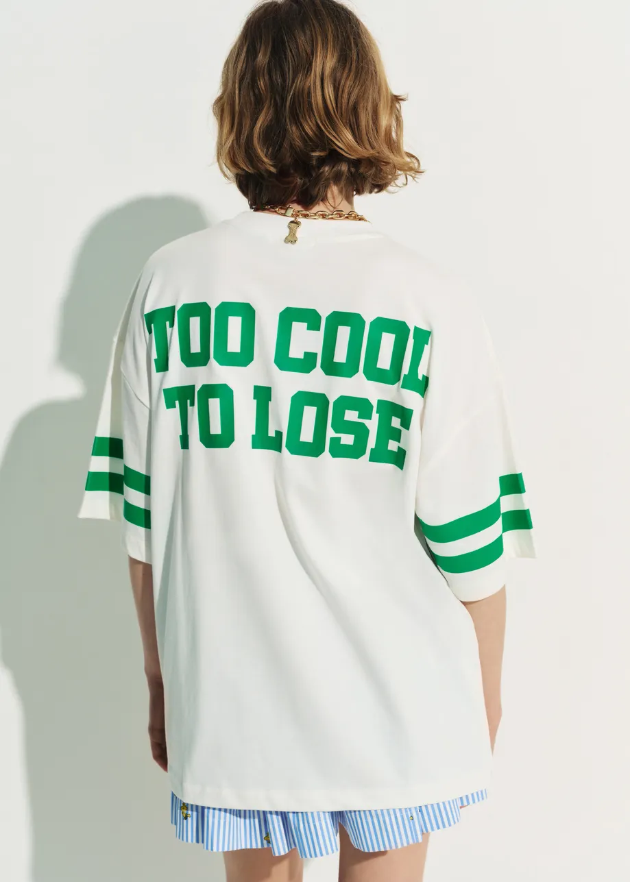 Off-white T-shirt with Peanuts™ Snoopy print and green text