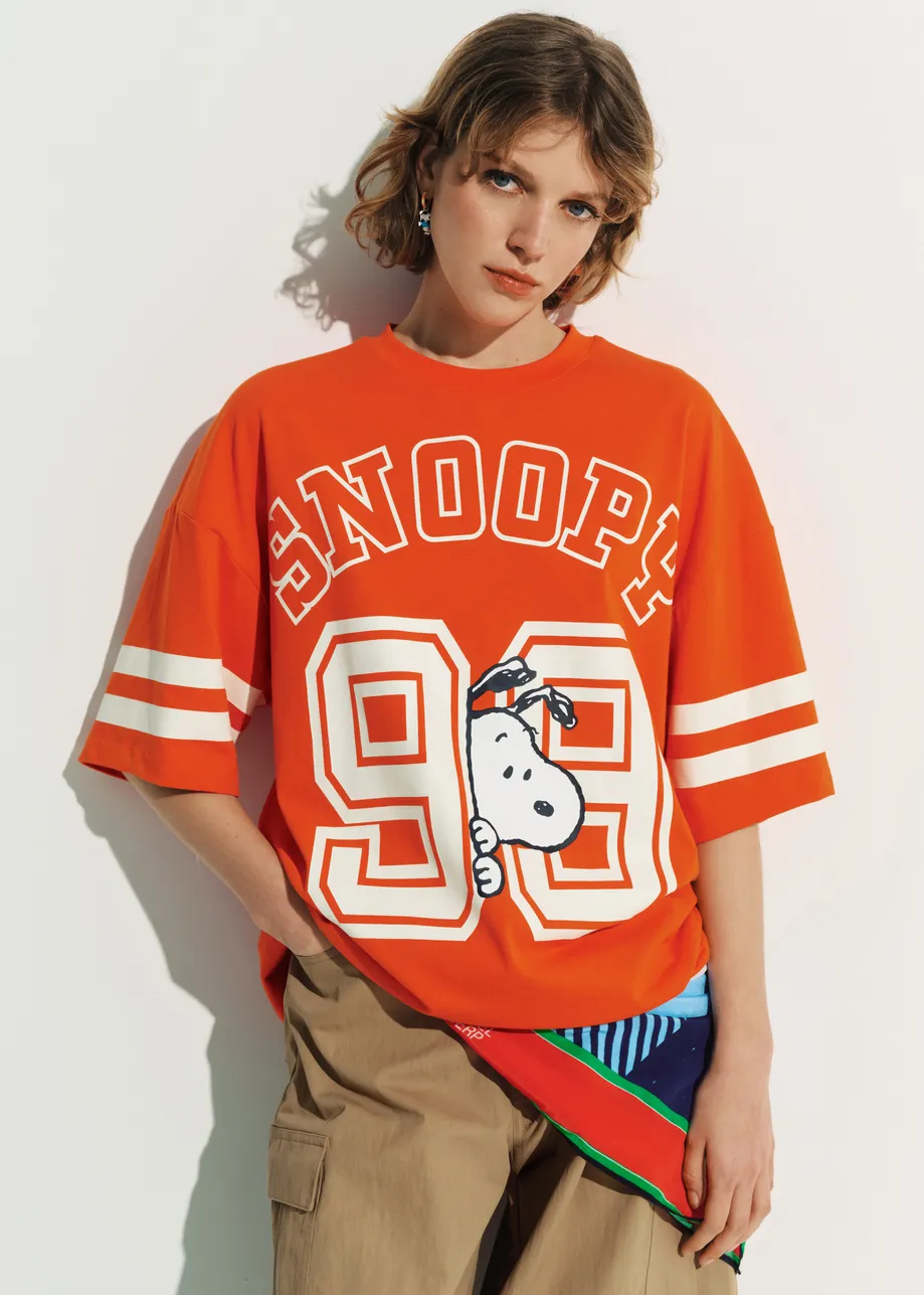 Orange T-shirt with Peanuts™ Snoopy print and white text