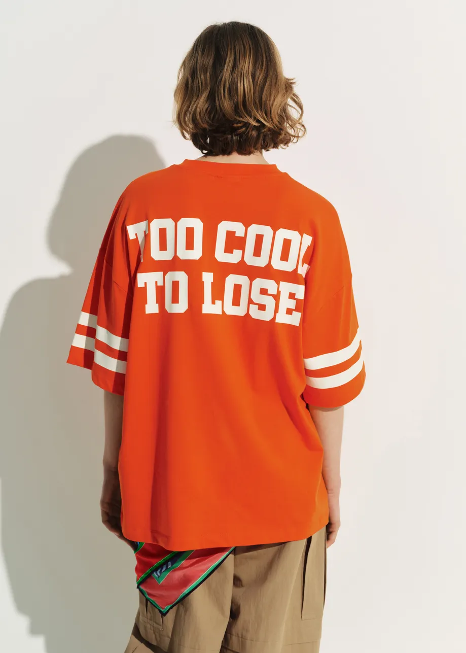 Orange T-shirt with Peanuts™ Snoopy print and white text