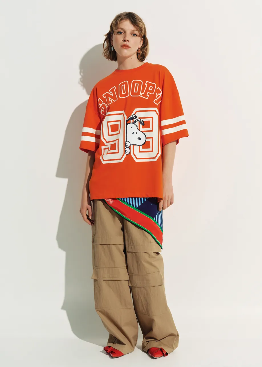 Orange T-shirt with Peanuts™ Snoopy print and white text