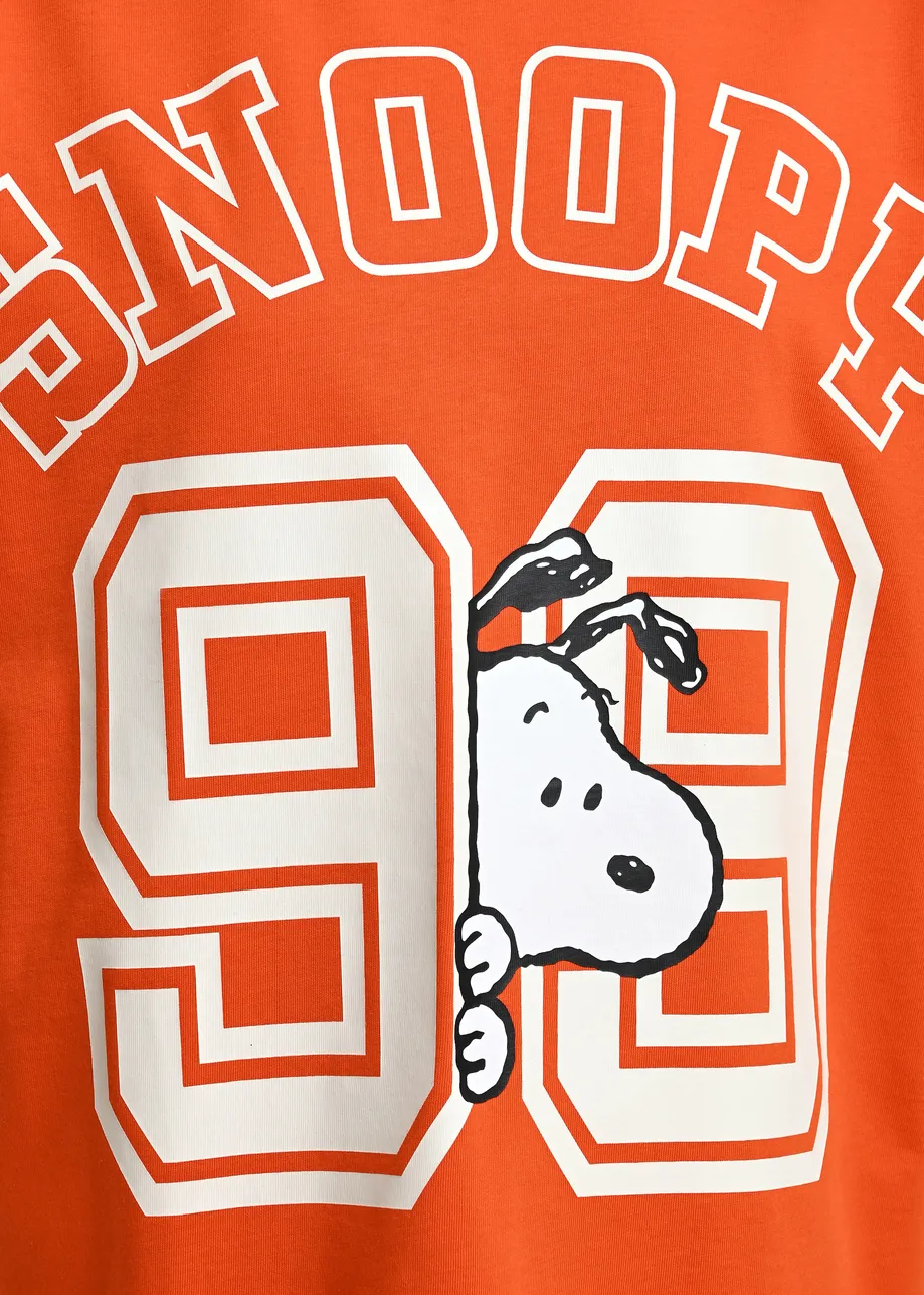 Orange T-shirt with Peanuts™ Snoopy print and white text