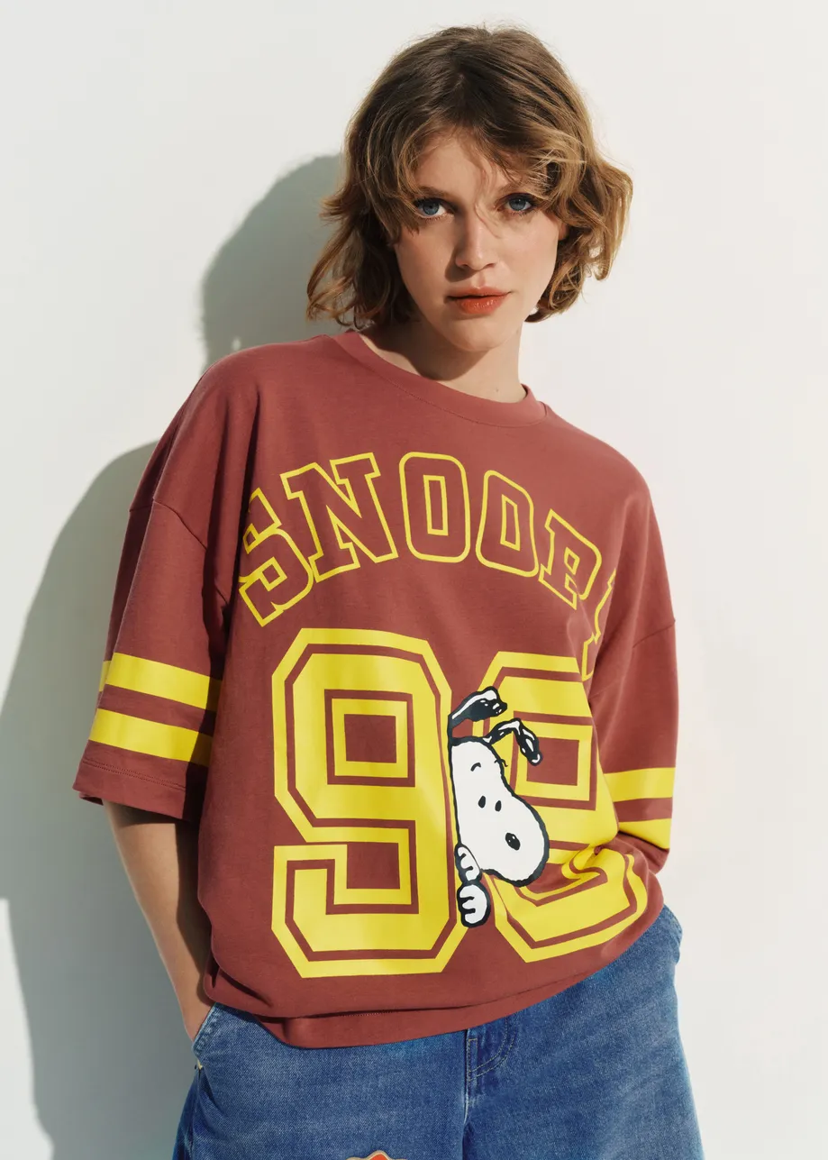 Brown T-shirt with Peanuts™ Snoopy print and yellow text